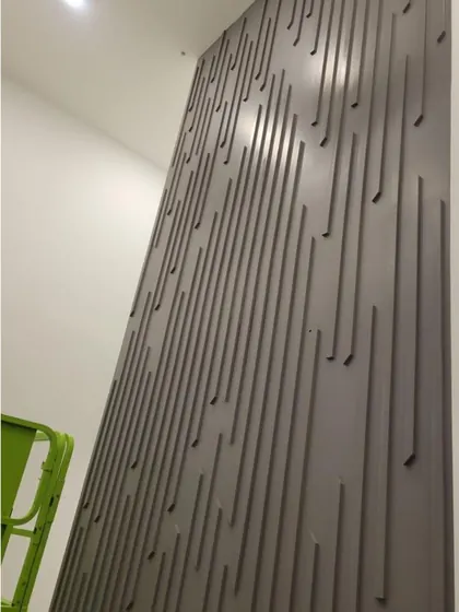 The finished slat accent wall running the full height of the room